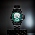 L'Orologio con teschio 3D black green di PACOSHOP è un orologio al quarzo in metallo nero con quadrante verde e teschio argentato dettagliato, esposto in verticale su un blocco di marmo nero su uno sfondo scuro e sfocato.