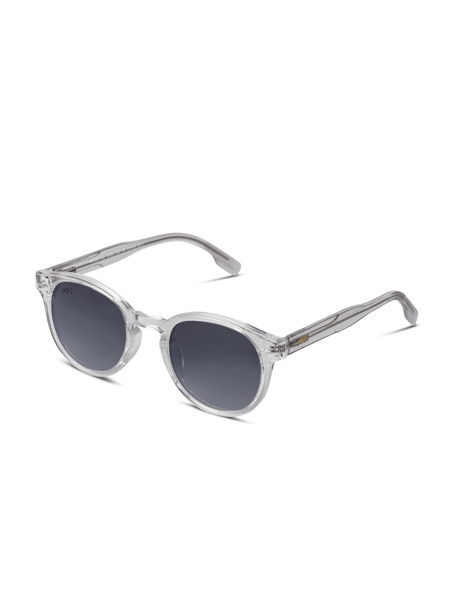 Gli occhiali da sole Luminatrix di X Frame Therapy, con montatura trasparente in acetato di cellulosa, lenti rotonde scure e aste spesse, offrono protezione UV e sono presentati su uno sfondo bianco.