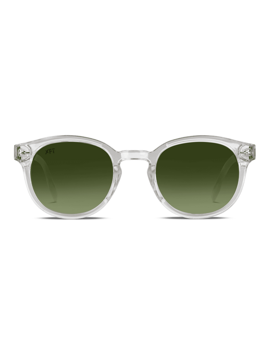 Gli occhiali da sole Luminatrix di X Frame Therapy presentano montatura trasparente in acetato di cellulosa e lenti tonde verdi sfumate con protezione UV, esposte su sfondo bianco.