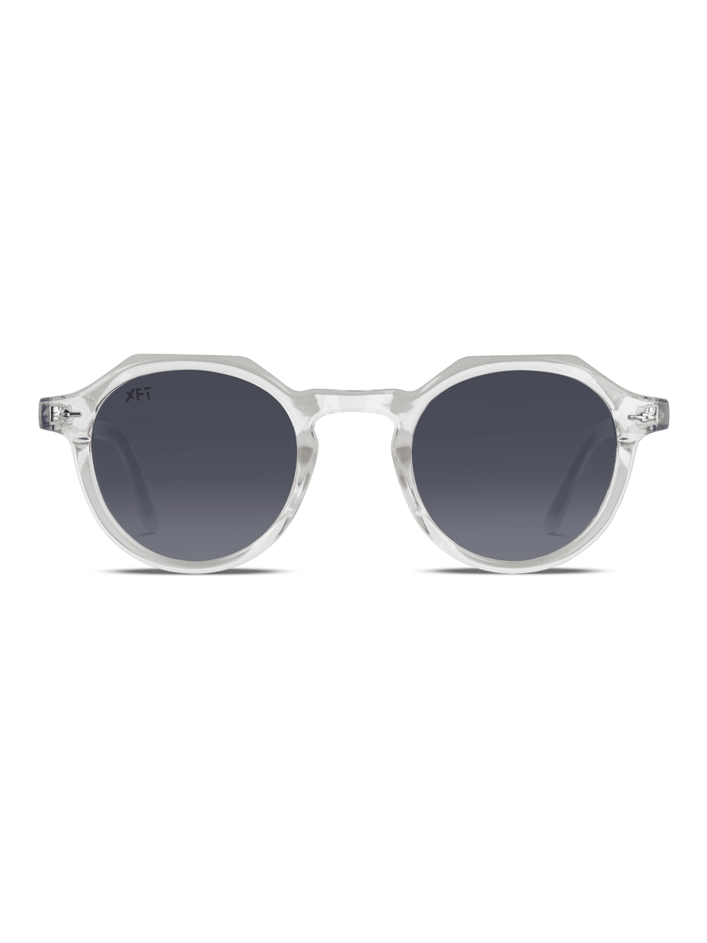 Gli Occhiali da sole Lucentia rotondo Unisex di X Frame Therapy sono caratterizzati da montatura chiara e traslucida e lenti scure sfumate, centrate su uno sfondo bianco. Godetevi un'elegante protezione UV400 con questi occhiali da sole XFT.