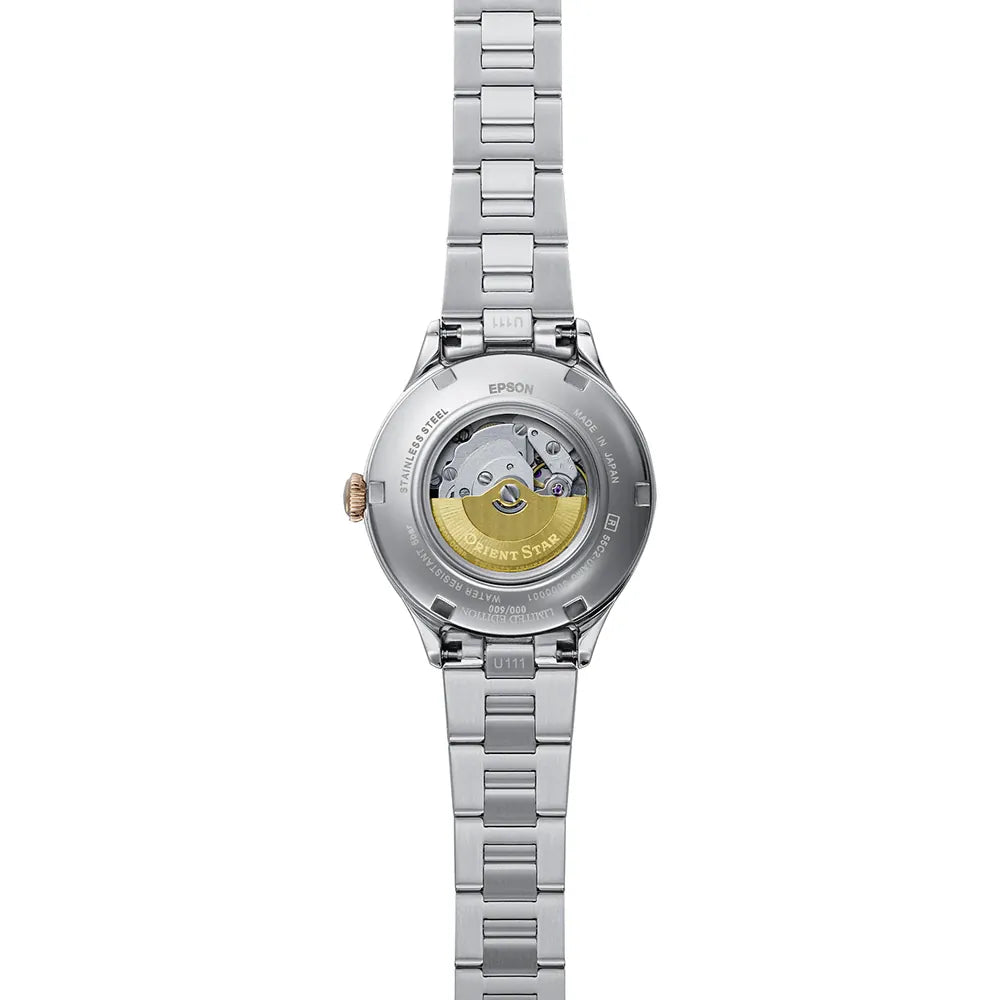 L'immagine mostra il fondello dell'Orient Star Classic Automatico RE-ND0022L00B di Orient, un orologio da donna color argento con bracciale in acciaio inossidabile e fondello trasparente che rivela il movimento meccanico e il rotore color oro con l'incisione Orient Star.