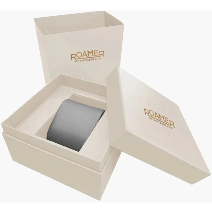 Scatola Roamer Toscana 994837474520 orologio uomo color crema con scritte in oro, aperta e chiusa; la scatola aperta rivela un cuscino grigio all'interno.